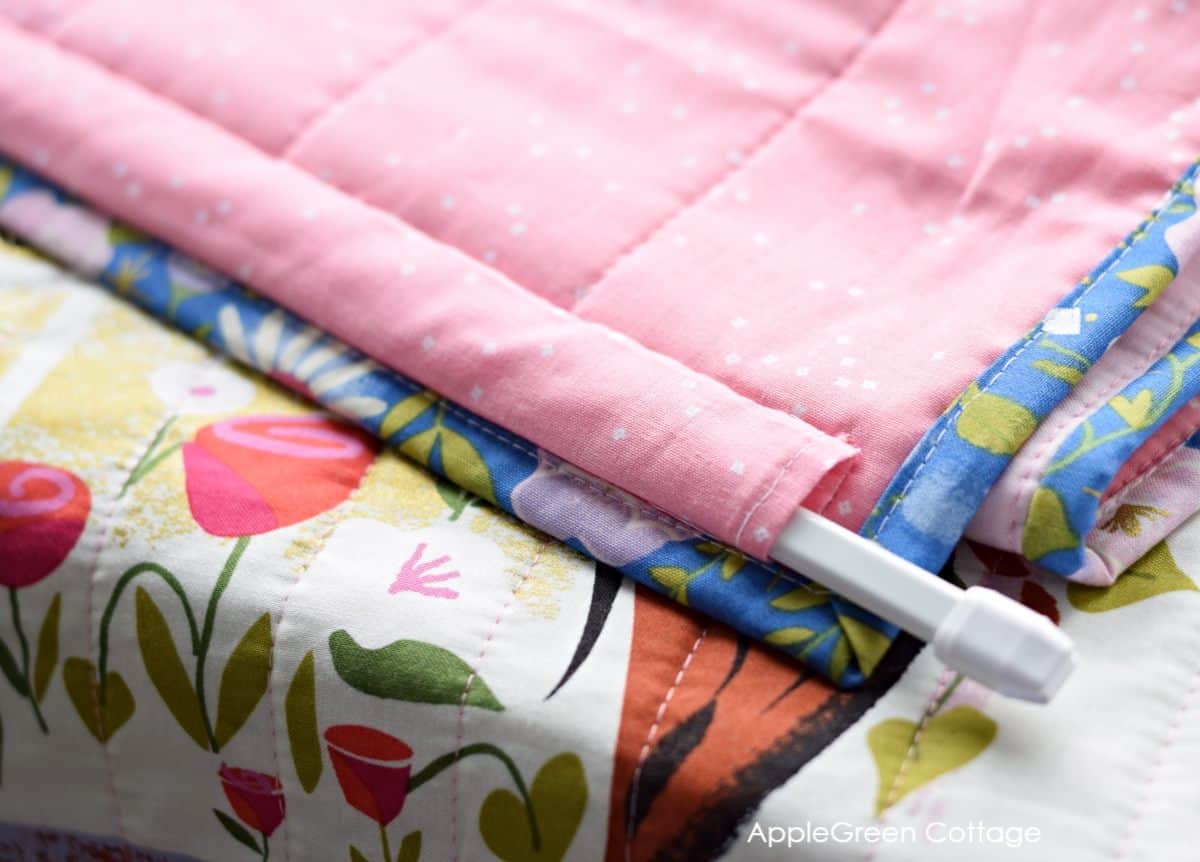 Need some quilt hanging ideas? Using dowel rods is one of many