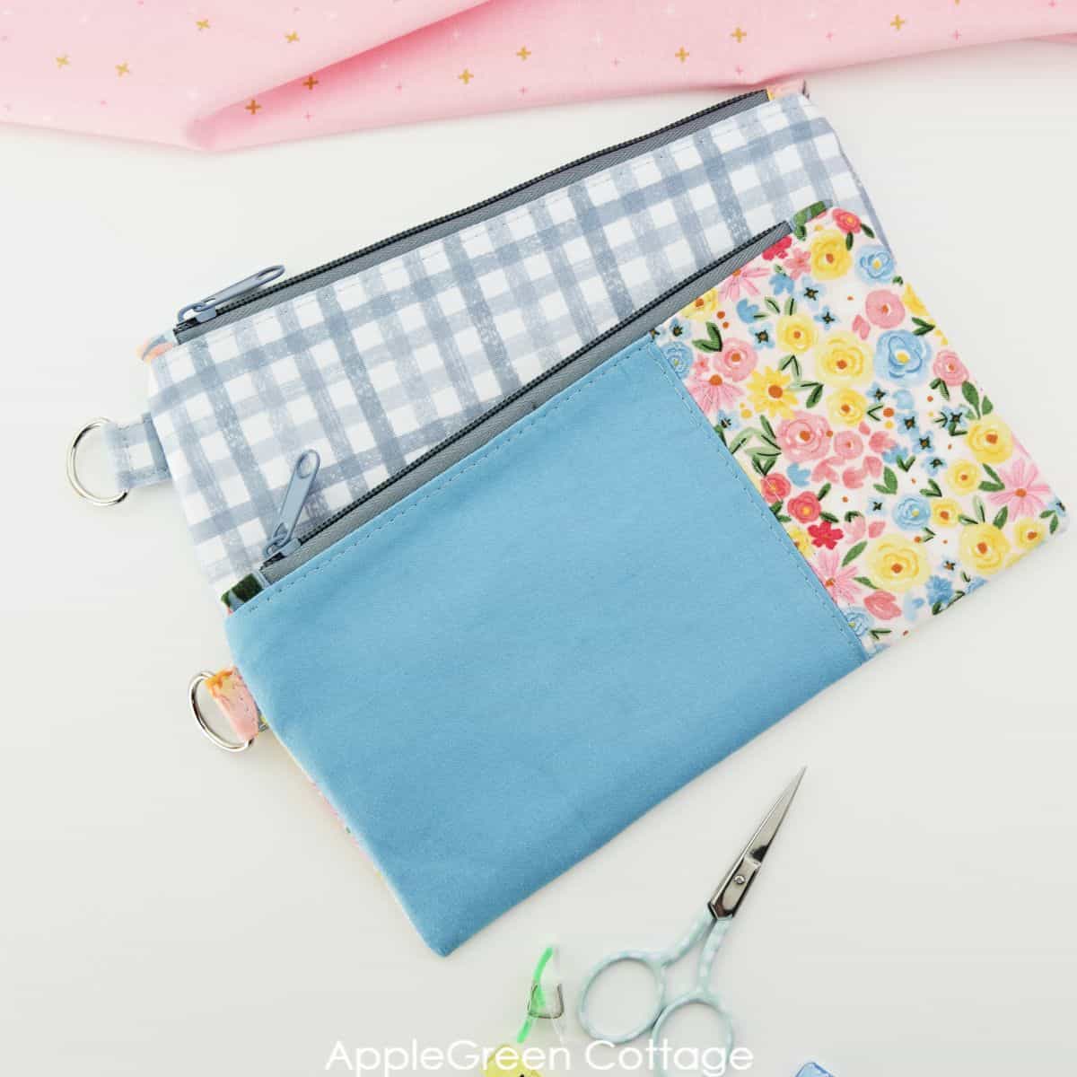 two rectangular flat zipper pouches,  one color blocked and one sewn from a single fabric piece