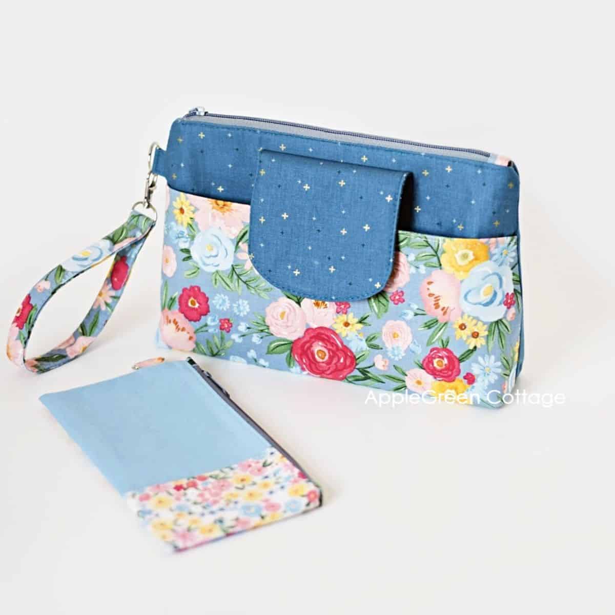 a set of a large zipper pouch in floral fabric and a flat rectangular fabric zipper pouch with a white background