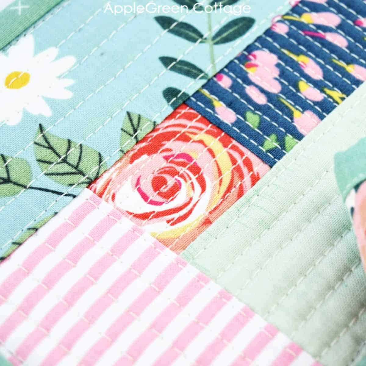 Matchstick quilting design on a floral patchwork quilt.