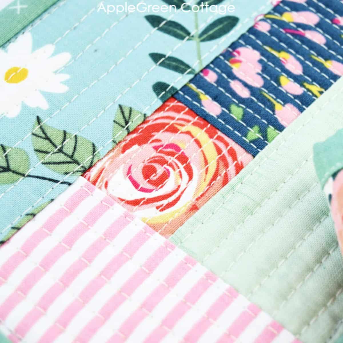 a qayg block sewn with florals, green and blue