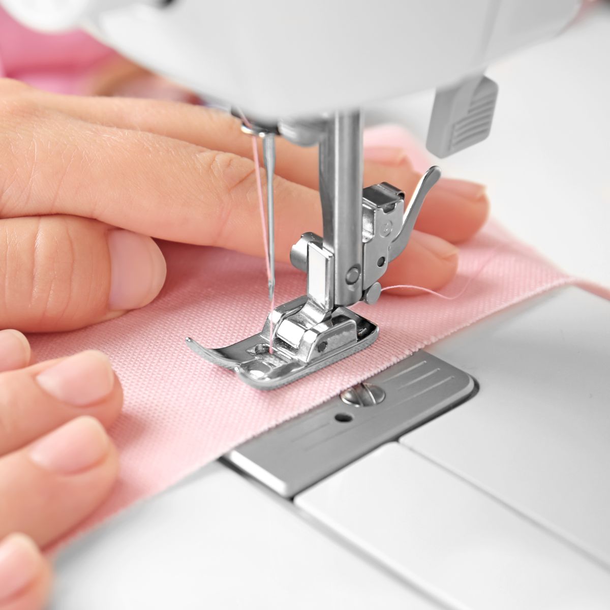 sewing machine foot with fabric underneath it