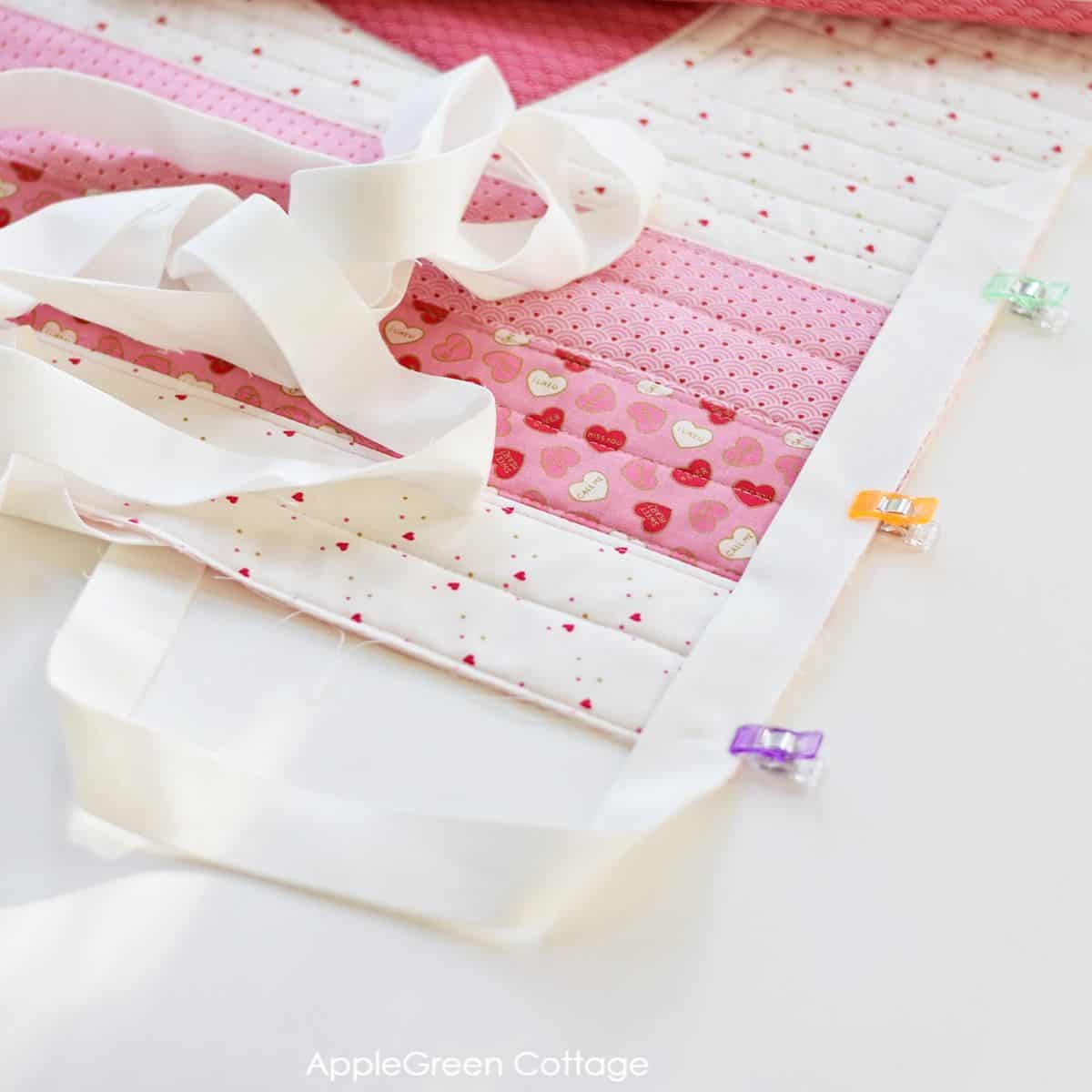 a strip of white binding for a quilted table runner 