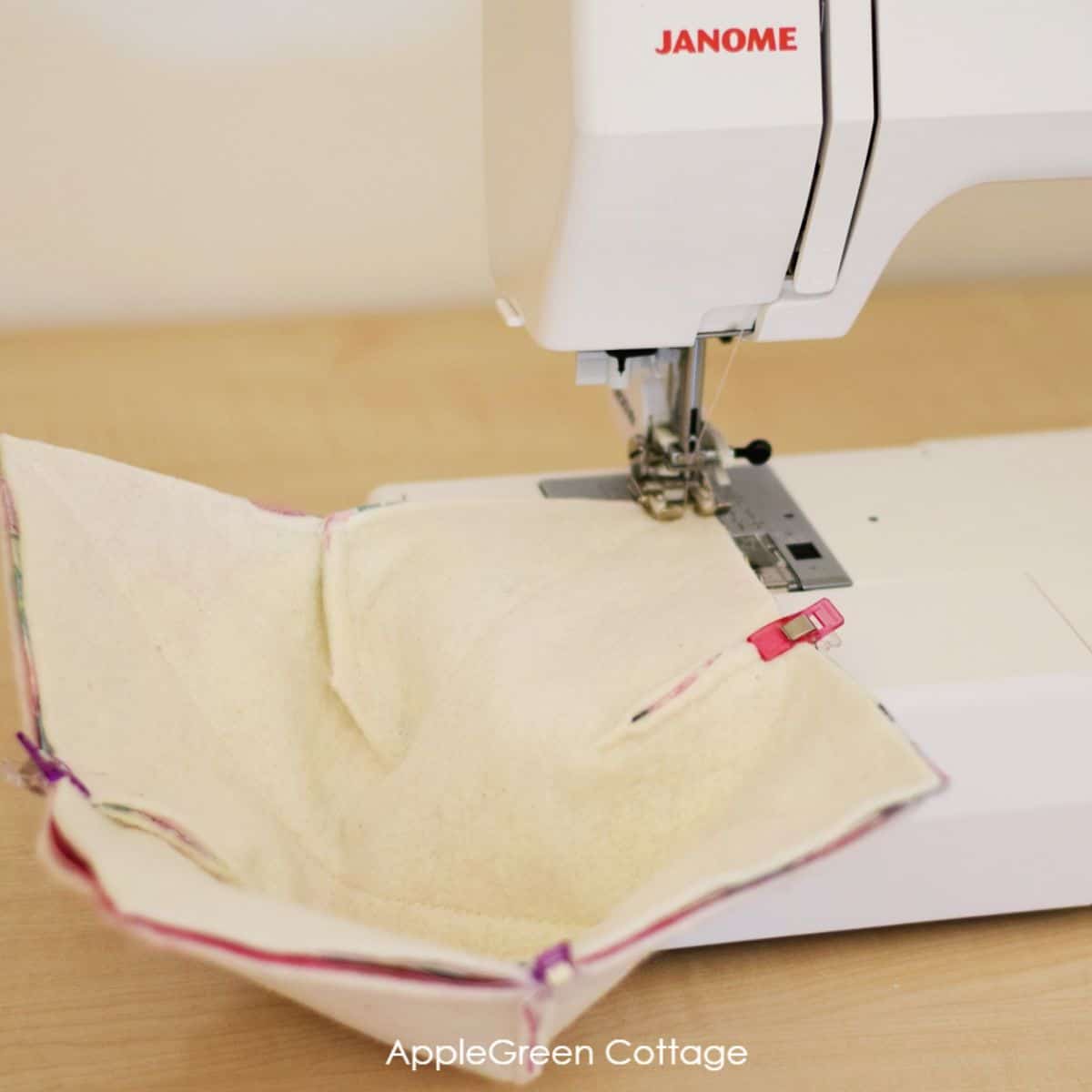 a janome sewing machine with a semi-finished fabric bowl cozy under the sewing foot