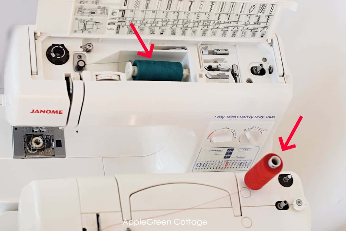 two sewing machines placed close to each other and with different top thread spool pins, one horizontal spool pin and the other with a vertical spool pin