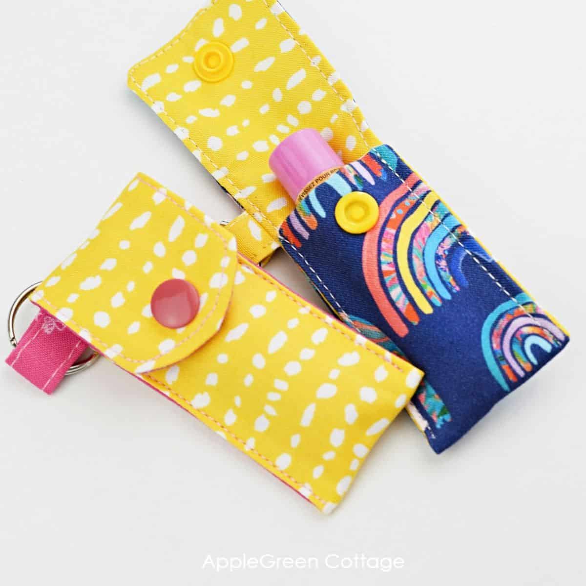 two sewn chapstick holder pouches in blue and yellow cotton, with a lip balm inserted 