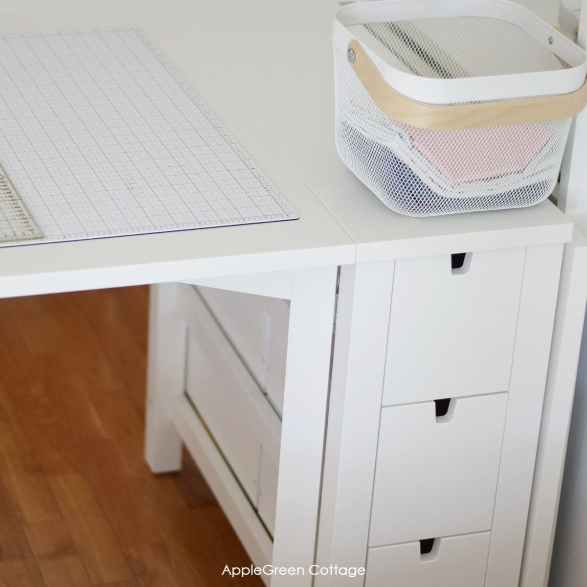 a white ikea gateleg table with removable drawers