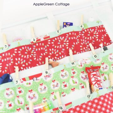 a closeup of a finished quilted advent calendar made with red, green and white prints and filled with treats