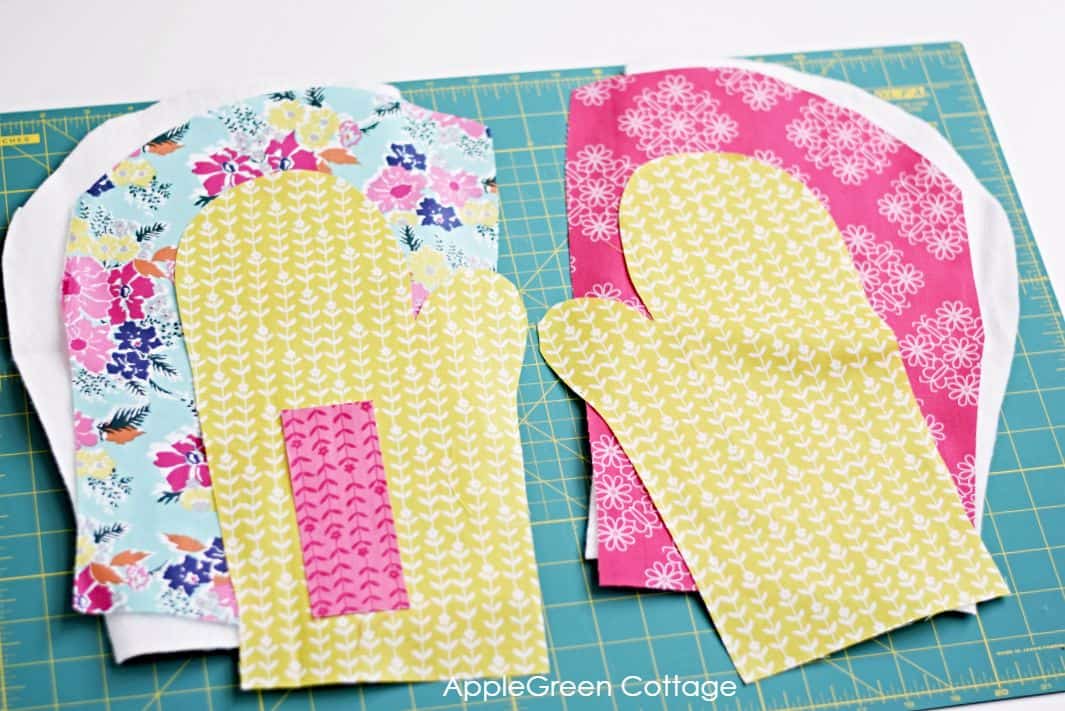 several oven mitten shaped fabric pieces cut to sew an oven mitt