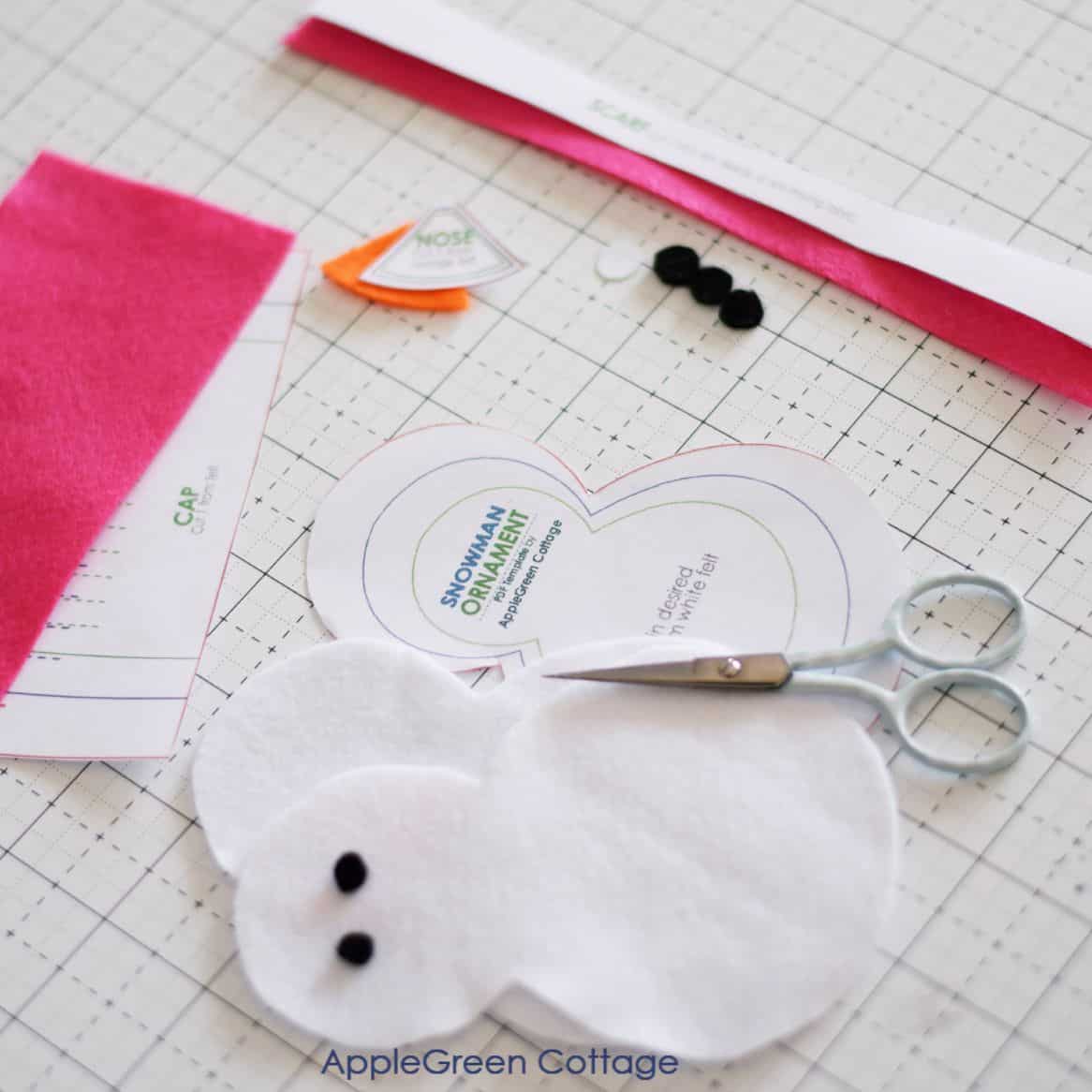 pieces of felt cut using the free snowman ornament sewing pattern