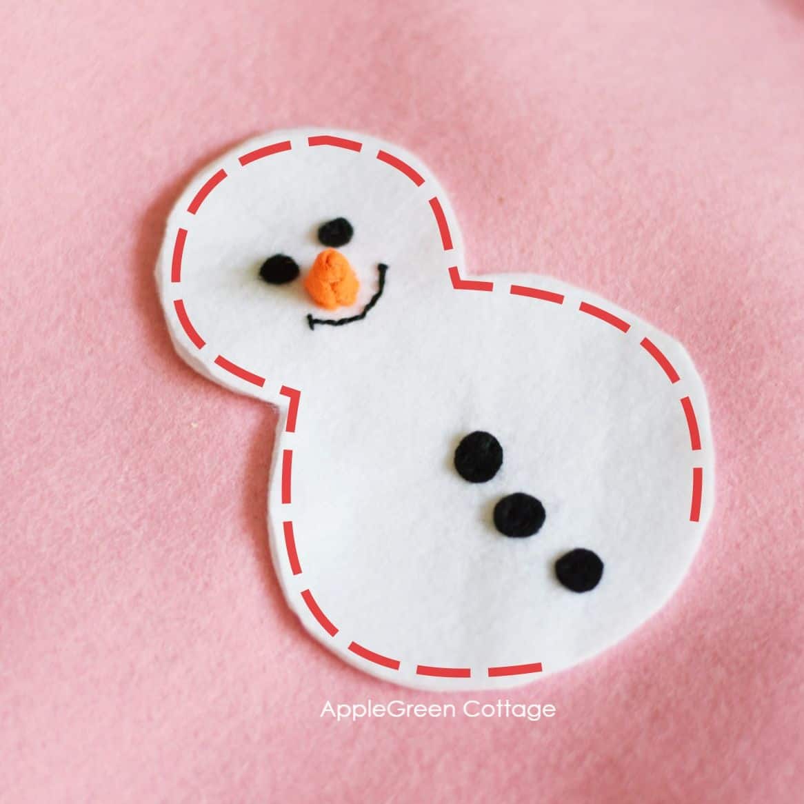 a dotted line marking the stitching line for a snowman ornament