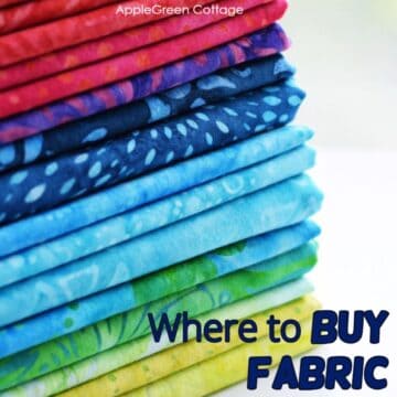 a pile of folded fabric prints in beautiful vivid colors