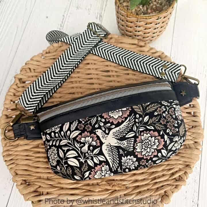 a finished fanny pack sewn with canvas and faux leather, featuring a beautiful print and brass bag hardware