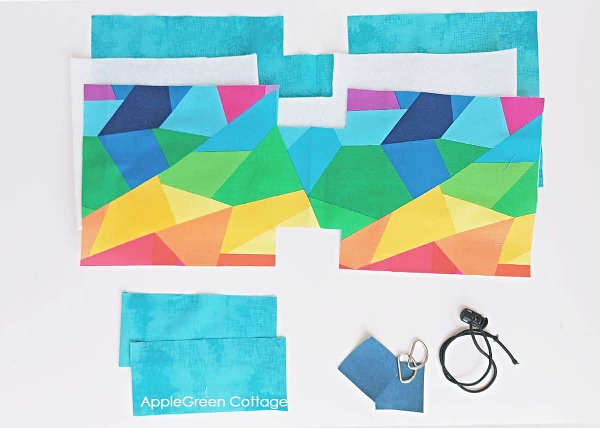 fabric pieces cut for sewing a water bottle holder bag