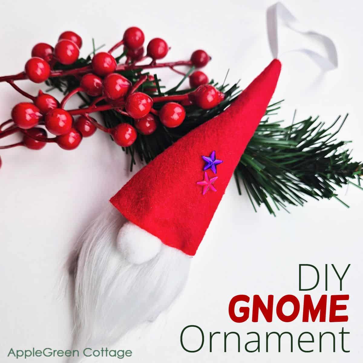 a finished handmade Christmas gnome ornament placed on holiday greenery