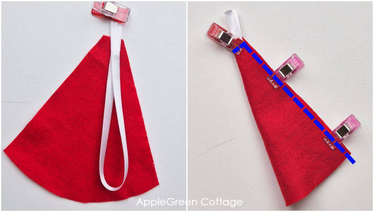 a semi-finished tiny gnome hat in red felt with a light beige background