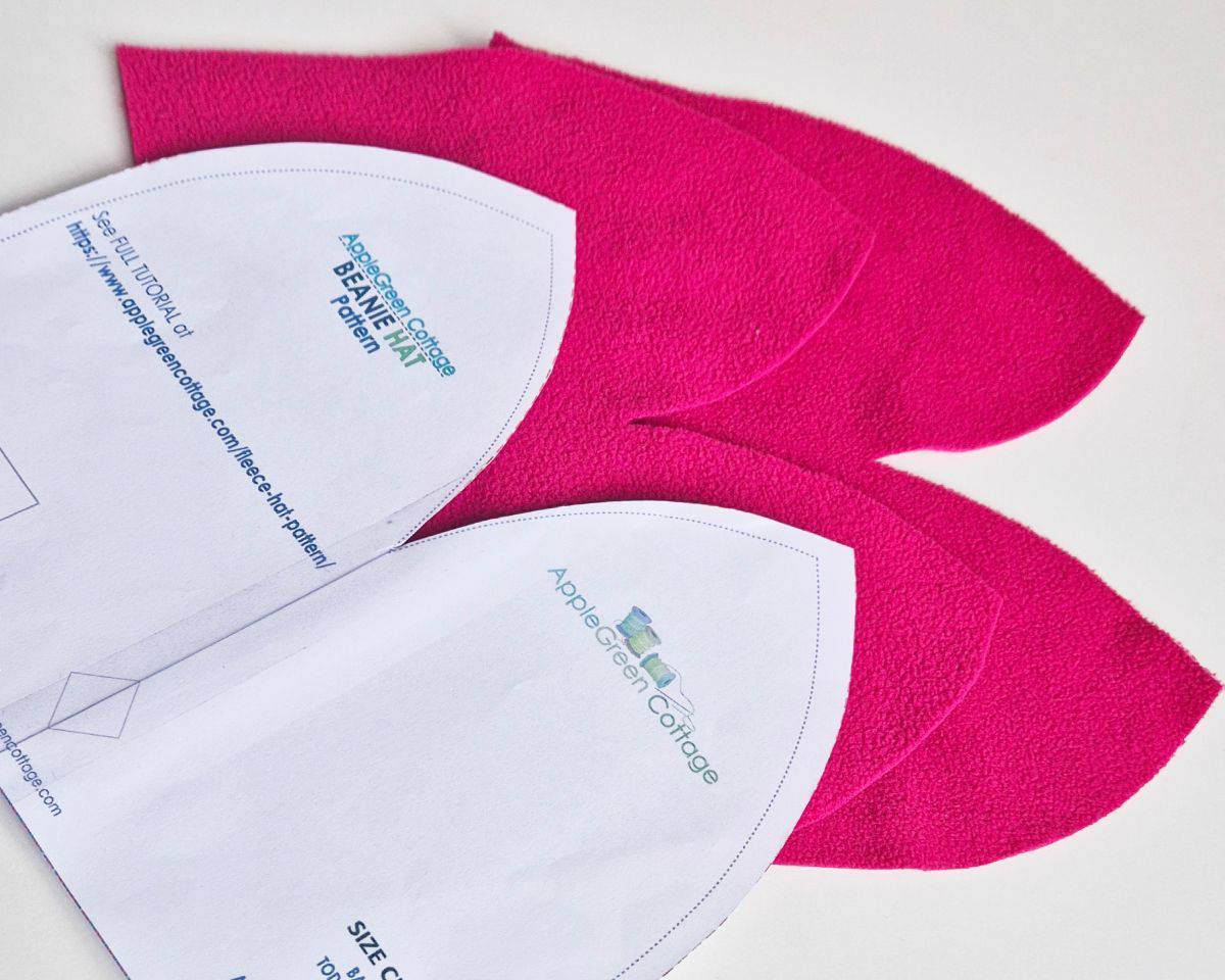 two pieces of felt cut in the shape of a beanie hat