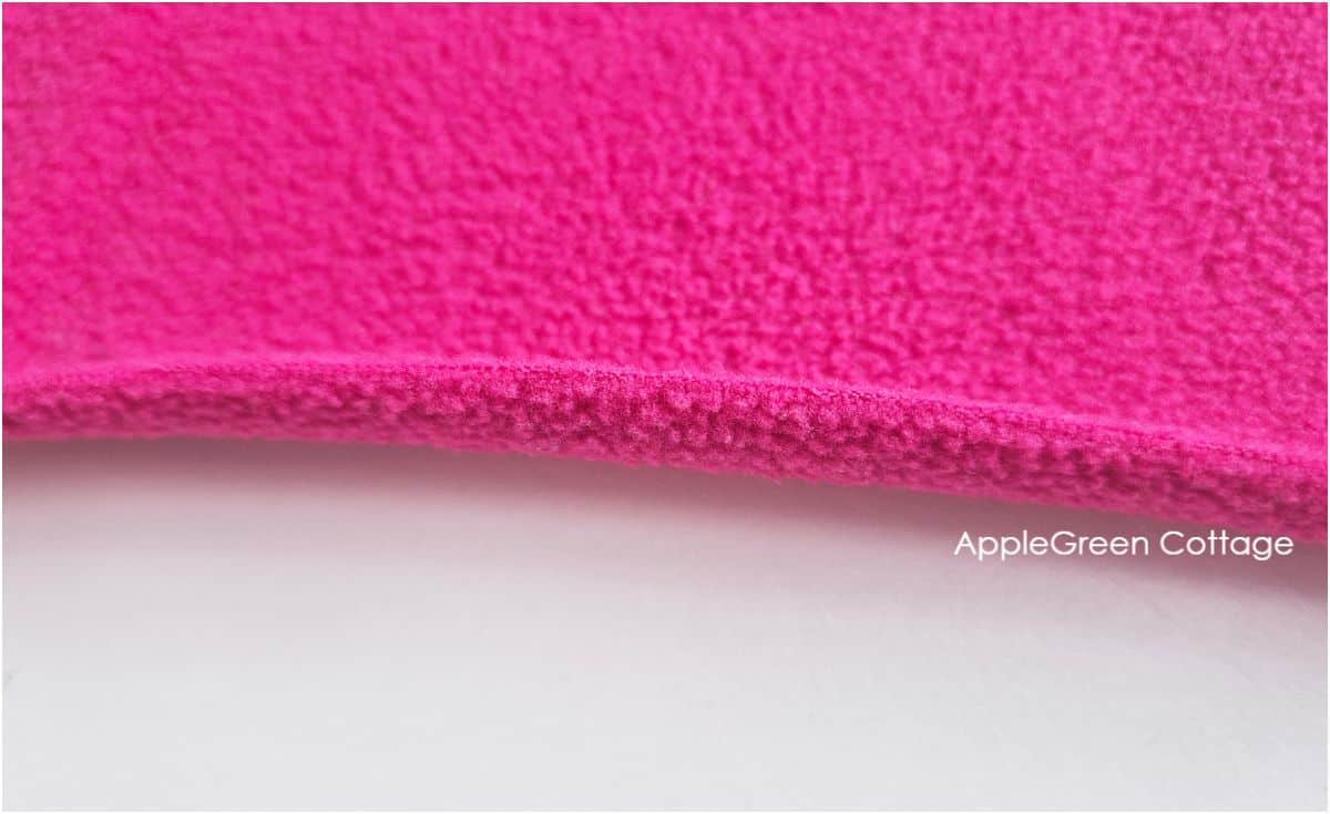 a piece of pink fleece, with the edge folding towards the wrong side