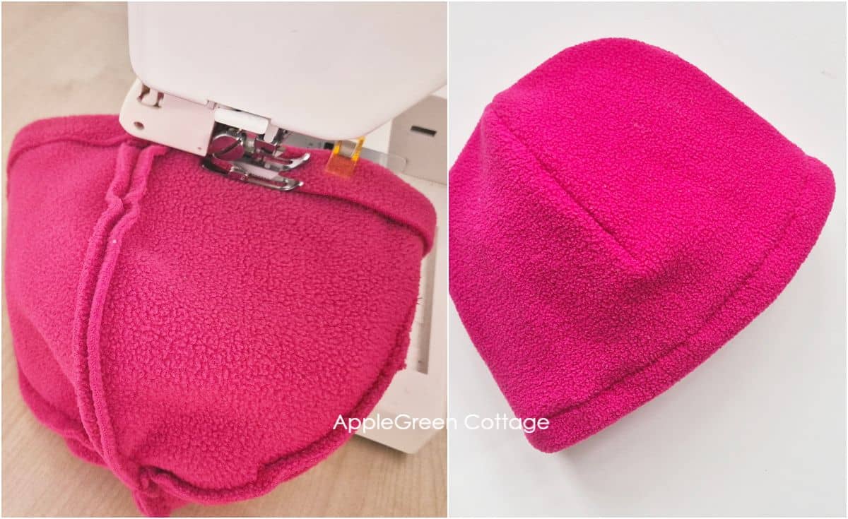 a sewing machine with a walking foot and a pink fleece beanie being hemmed