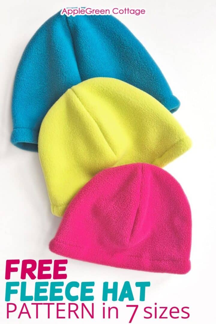three finished fleece beanies in teal, hot pink and neon colors