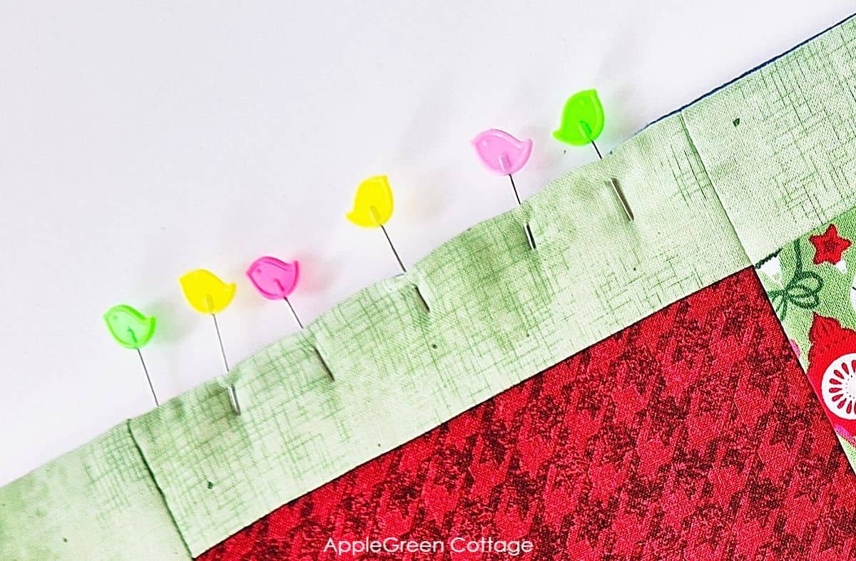 a turning hole on a semi-finished quilt, with pins holding the layers together
