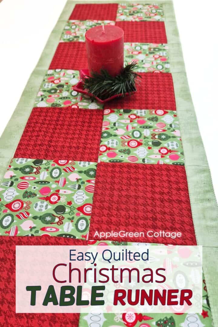 A beautiful quilted Christmas table runner featuring red and green christmas prints, perfect for enhancing holiday dining decor