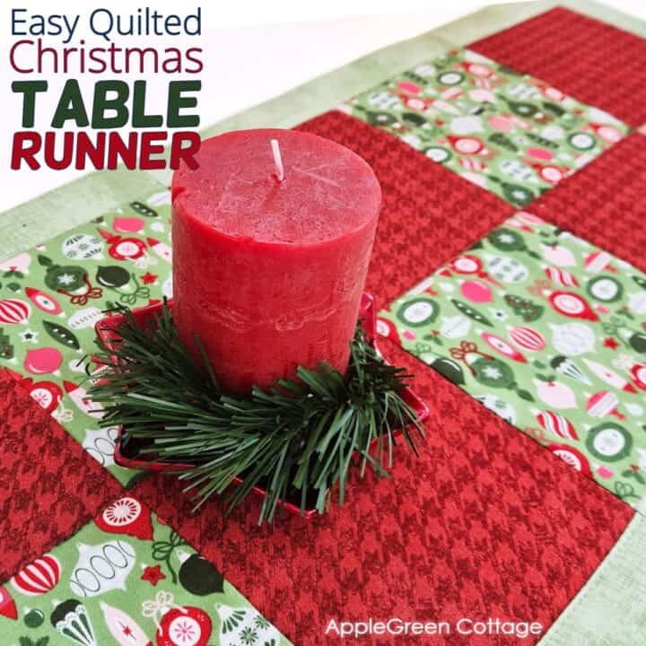 A beautiful quilted Christmas table runner featuring red and green christmas prints, perfect for enhancing holiday dining decor