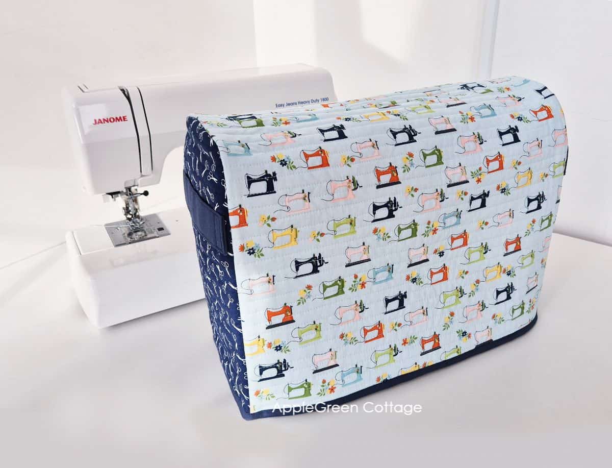 Finished sewing machine cover pattern paired with a Janome sewing machine on display.