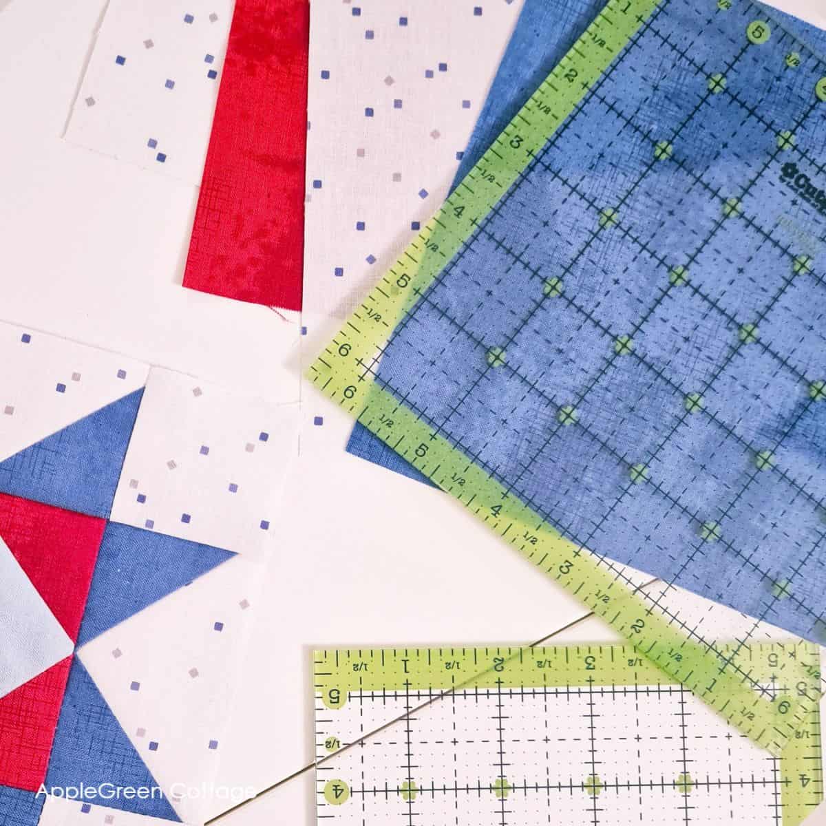 Quilting rulers alongside bold red, white, and blue quilt blocks. Perfect for crafting patriotic or beginner-friendly quilting patterns.