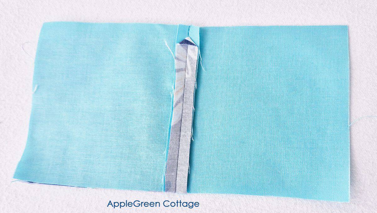 Back view of a 1-seam flying geese block showing pressed seams, highlighting the clean and precise construction.