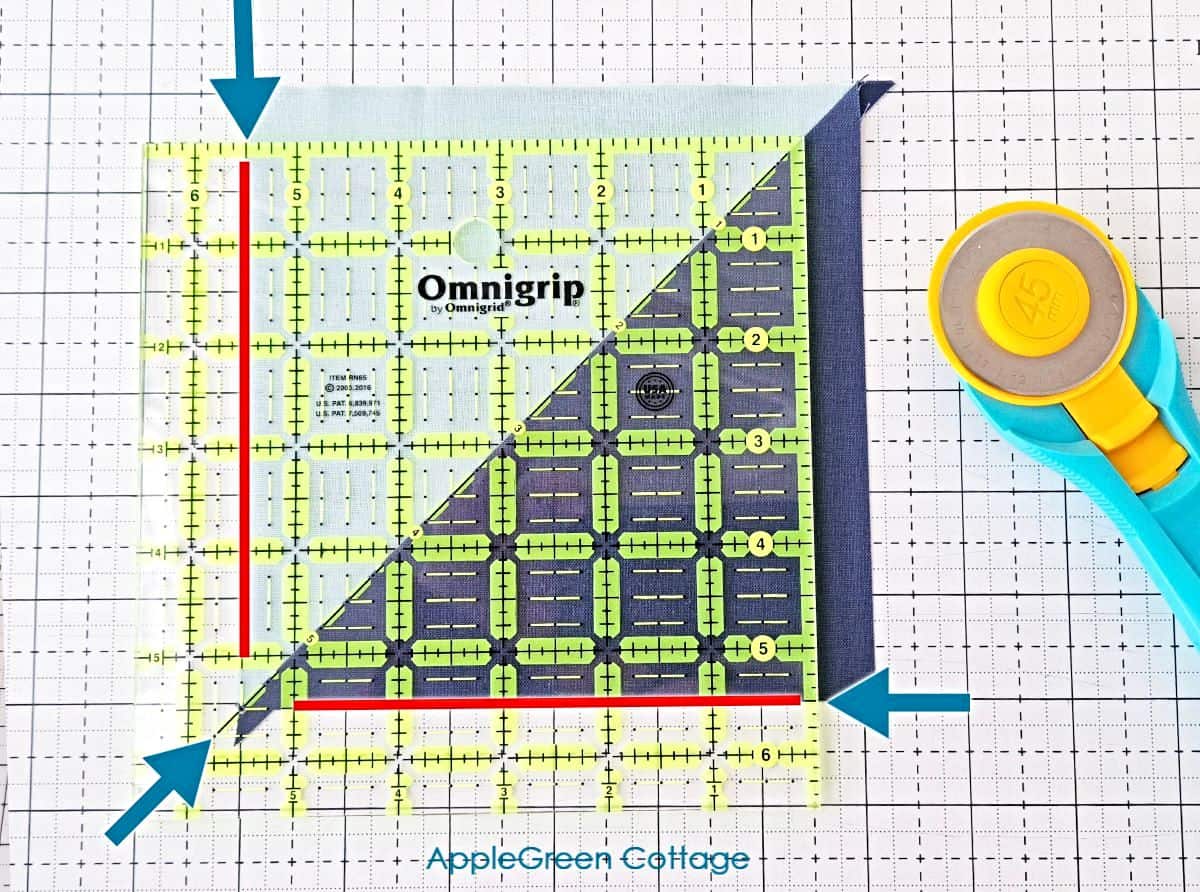 Cutting HST blocks using a rotary cutter and ruler for quilting.