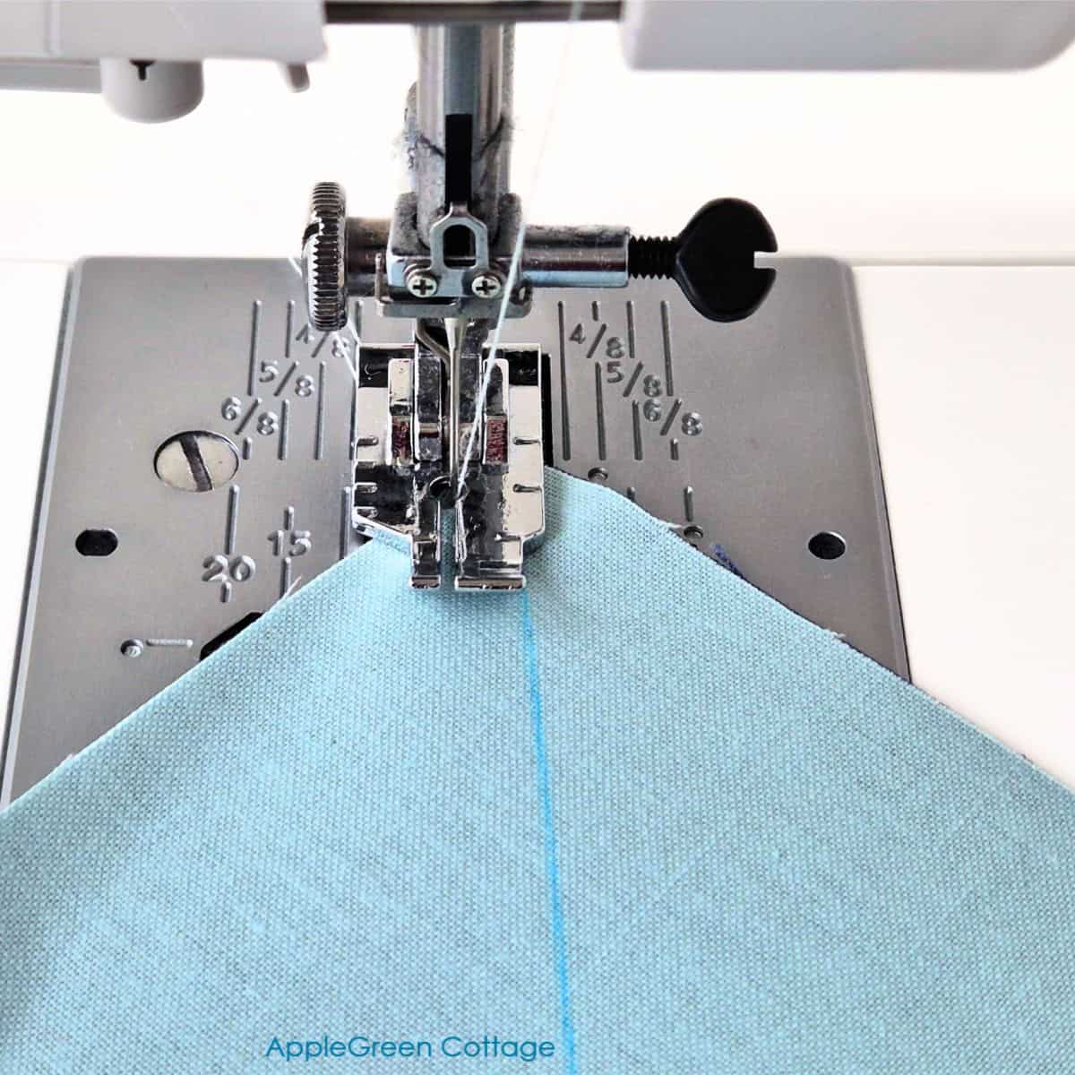 Sewing a diagonal line on fabric for Half Square Triangle blocks.