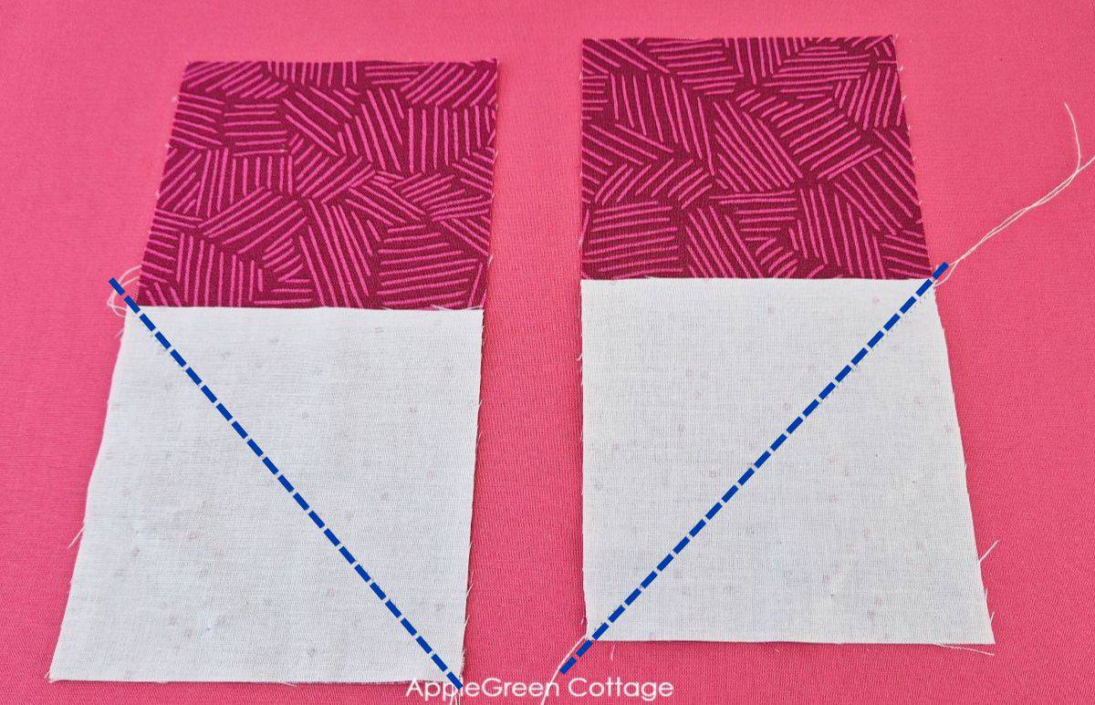 White squares stitched diagonally to red printed fabric rectangles, part of a heart quilt block sewing process.