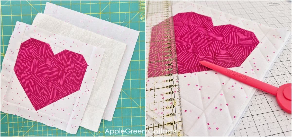 Layers of batting and backing arranged under a pink pieced heart quilt block, ready for quilting.