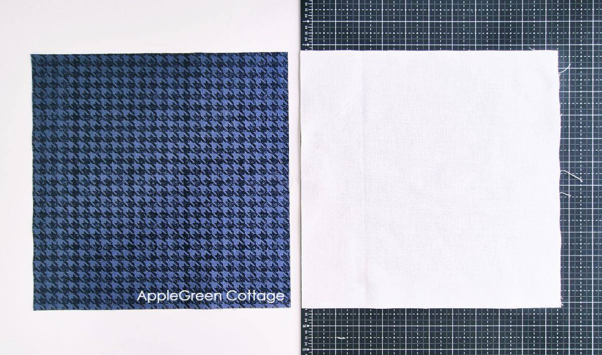 Two fabric squares, one dark patterned and one light, prepared for making eight-at-a-time half-square triangles (HSTs).