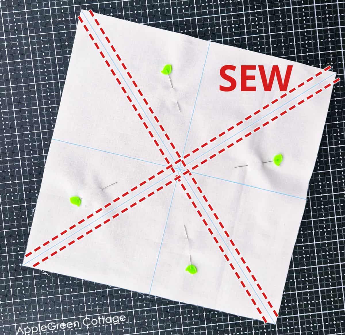 Pinned fabric squares with sewing lines marked for eight-at-a-time half-square triangles.