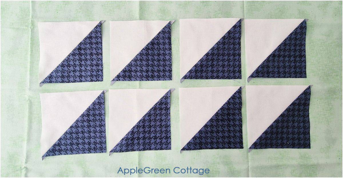 Eight finished half-square triangles, pressed and ready for squaring up.
