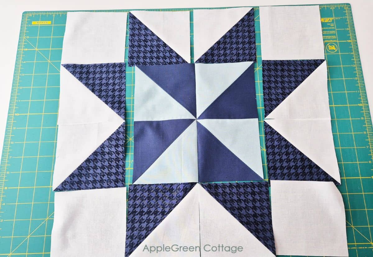Quilt block arrangement for a pinwheel star mini quilt.