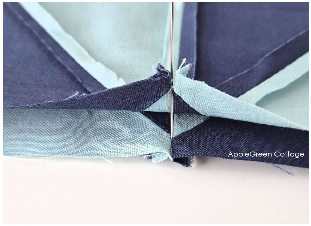 Close-up of aligned seams in a pinwheel quilt block – Ensuring perfect seam alignment at the center for a precise quilt block finish.