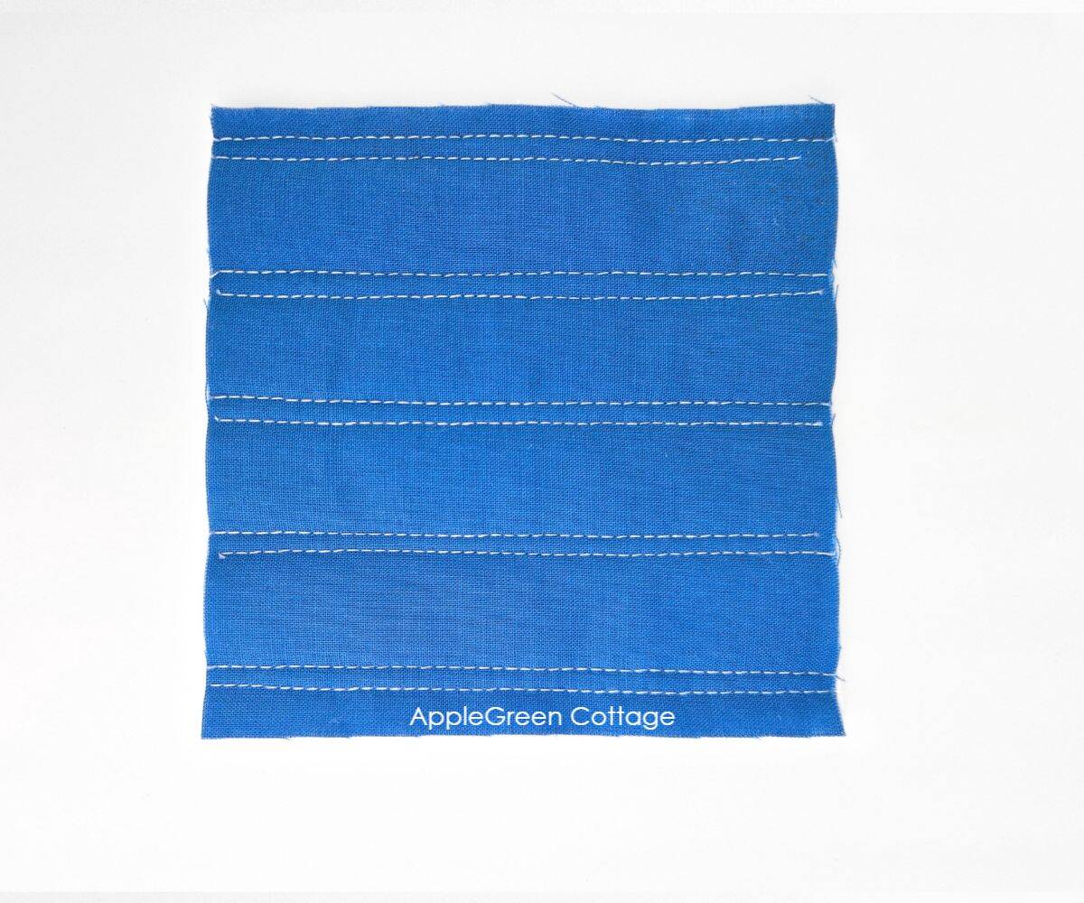 Easy double straight-line quilting design on blue fabric.
