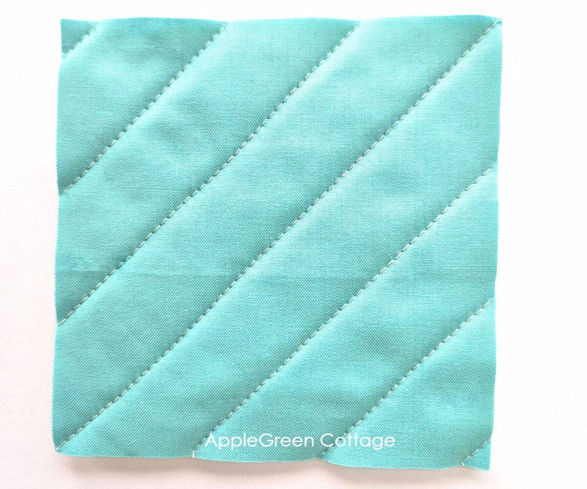 Diagonal quilting on solid fabric – A quick and easy straight-line quilting method that adds movement to any quilt.