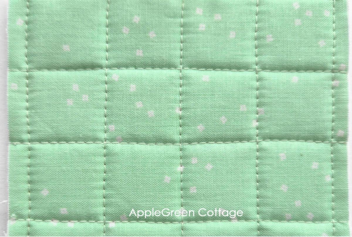 Dense grid quilting on green fabric – Create a structured, textured look with this simple square grid quilting design.