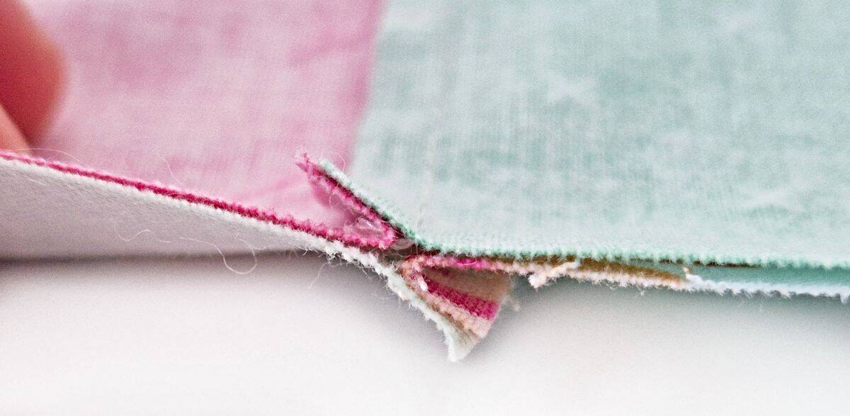 Pinning and sewing rows with seam nesting close-up.
