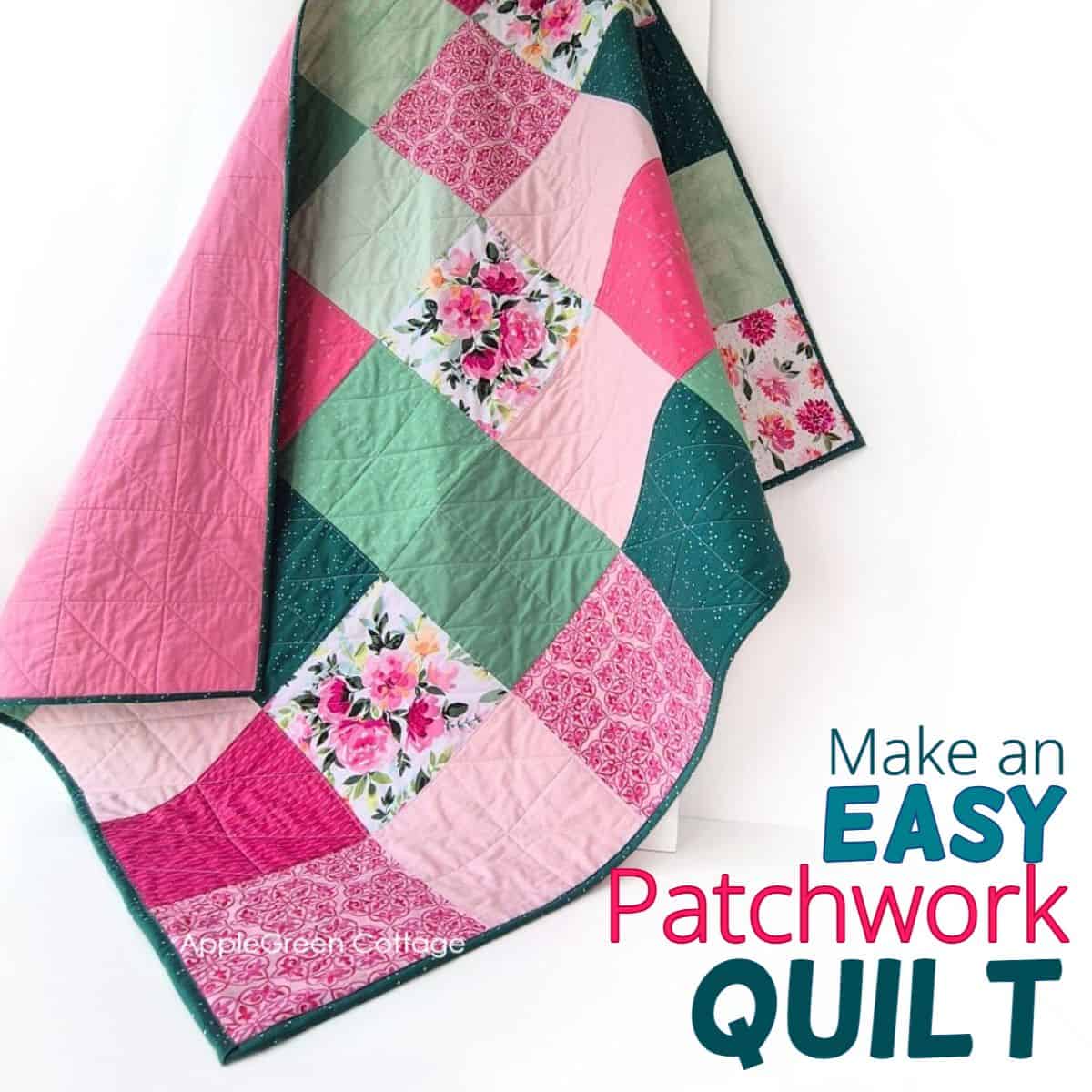 Handmade patchwork quilt in pink and green with floral pattern squares, featuring quilted stitching and dark green binding.