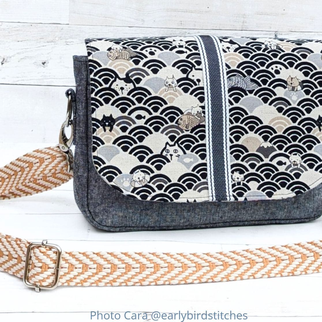 Small crossbody bag made with Essex linen and cat print fabric, featuring webbing strap and flap closure.