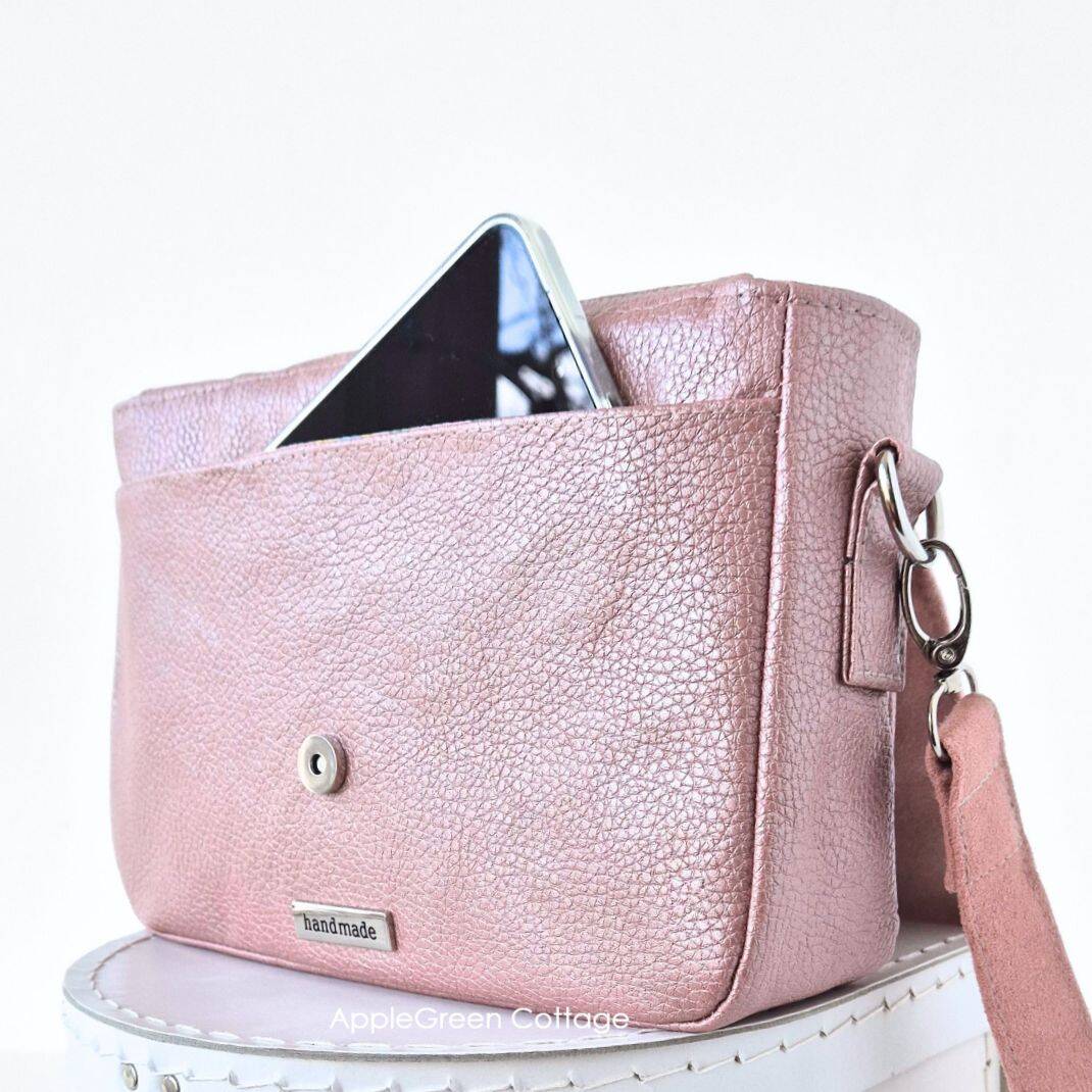 Pink faux leather crossbody bag with magnetic flap and phone pocket, made using the Elarina purse sewing pattern.