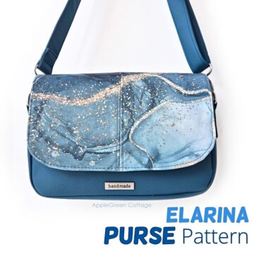 Blue handmade Elarina crossbody bag with marbled flap design, displayed hanging by its strap.