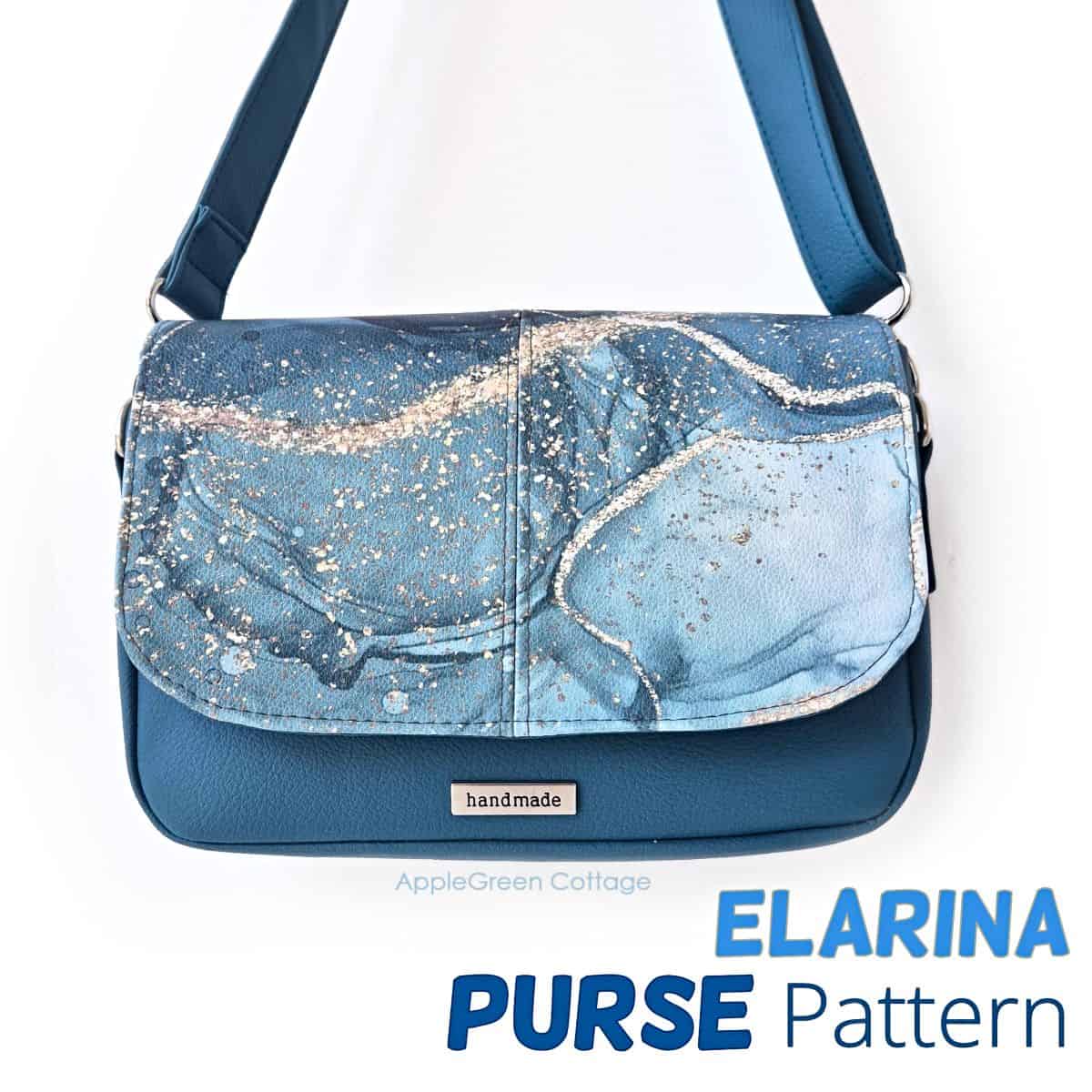 Blue handmade Elarina crossbody bag with marbled flap design, displayed hanging by its strap.