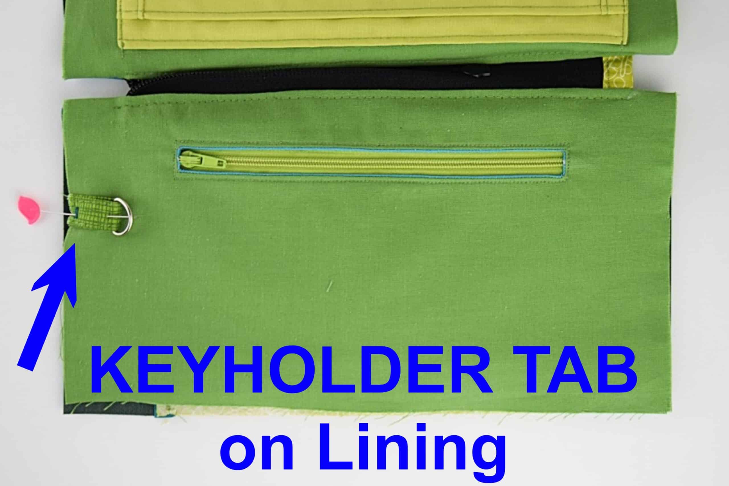 A bag anchor tab with a d-ring attached to bag lining.