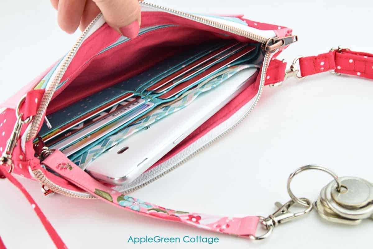 a handmade bag with an inserted detachable keyholder in beautiful red floral print with keys attached.